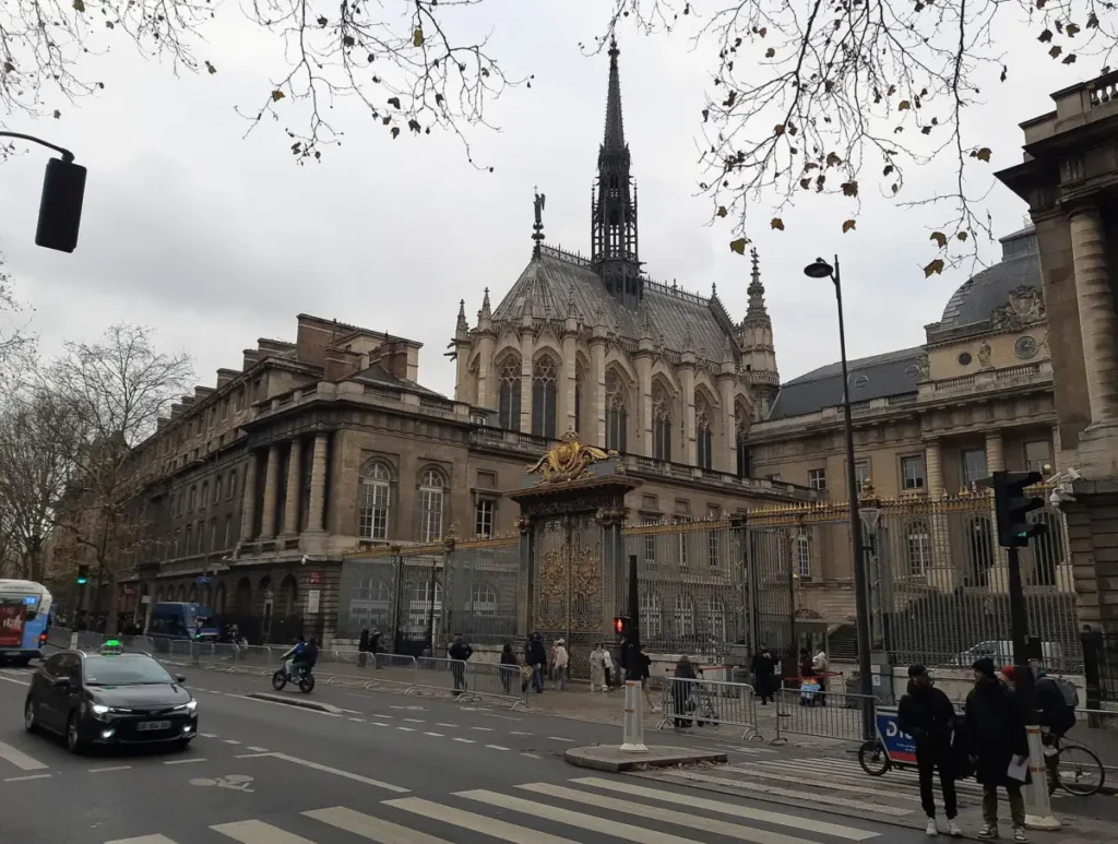 Sainte-Chapelle spire behind the Palais de Justice gates on Boulevard du Palais